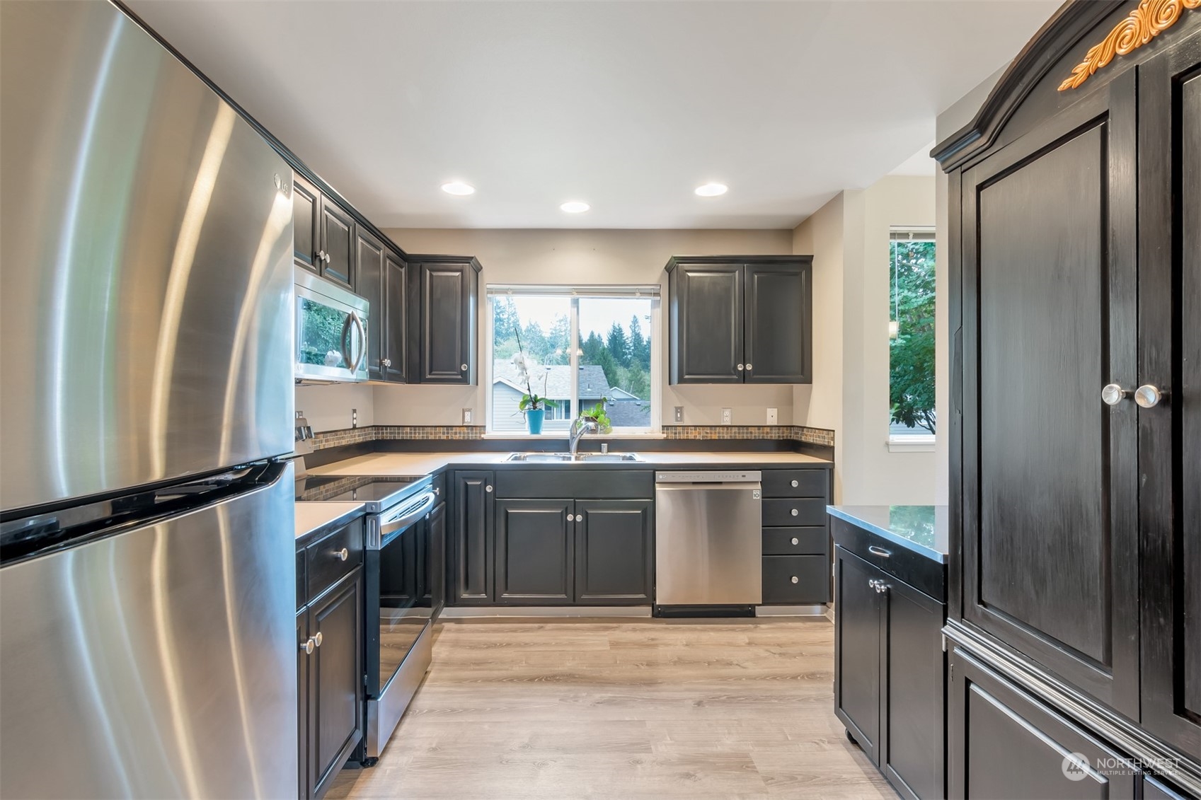 13197 Icicle Ridge Road Southeast Monroe, WA 98272 - Photo 4 of 25 a kitchen with granite countertop a refrigerator and a sink