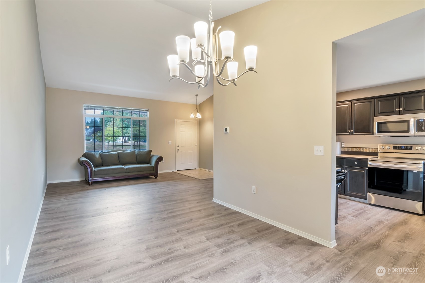 13197 Icicle Ridge Road Southeast Monroe, WA 98272 - Photo 7 of 25 a view of a livingroom with furniture wooden floor and a chandelier