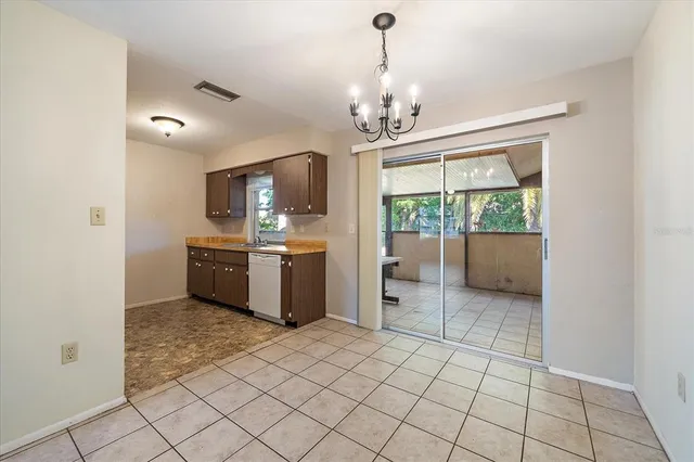a view of a kitchen with a sink and a refrigerator