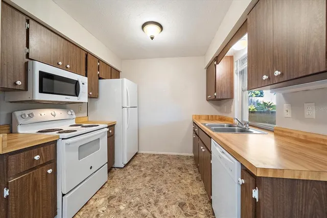 a kitchen with a stove a sink and a refrigerator