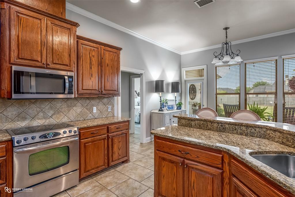 425 Kingston Road Benton, LA 71006 - Photo 12 of 35 a kitchen with granite countertop cabinets stainless steel appliances and a counter space