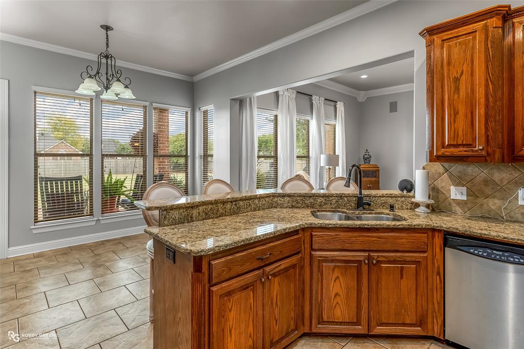 425 Kingston Road Benton, LA 71006 - Photo 13 of 35 a kitchen with a granite countertop sink and wooden floor