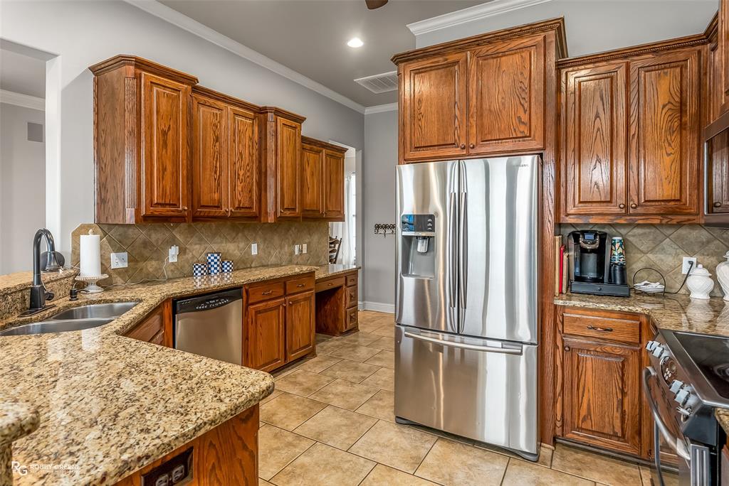 425 Kingston Road Benton, LA 71006 - Photo 14 of 35 a kitchen with stainless steel appliances granite countertop a refrigerator sink and cabinets