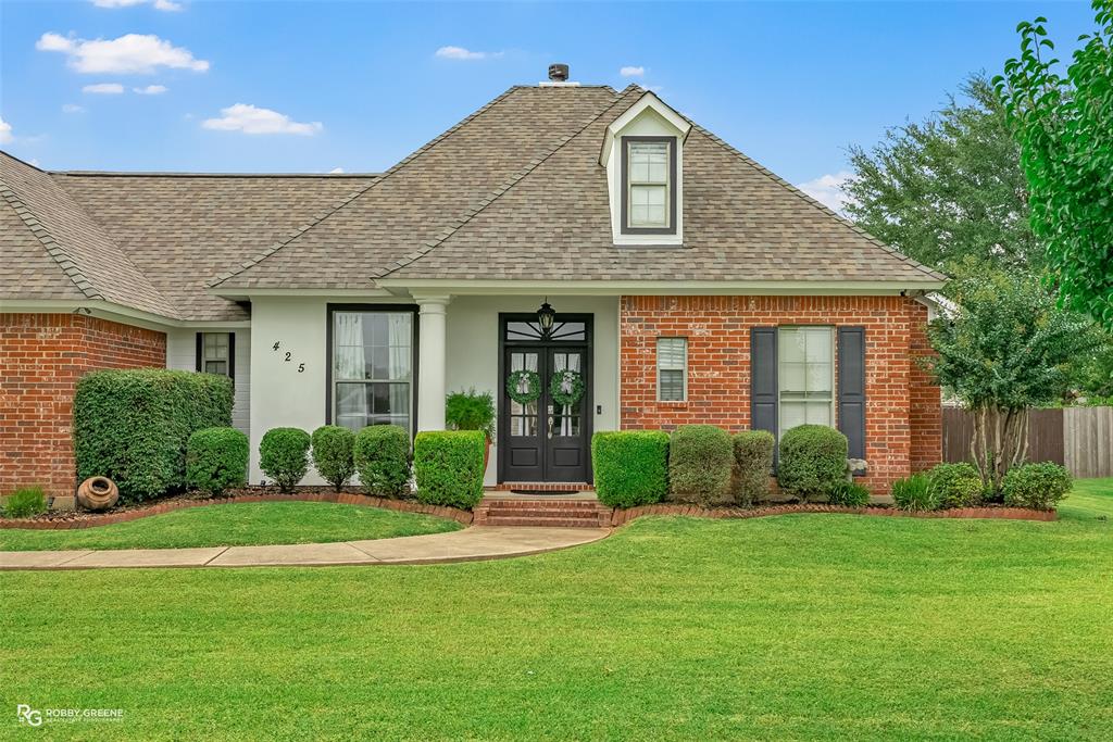 425 Kingston Road Benton, LA 71006 - Photo 2 of 35 a front view of a house with a yard and garage