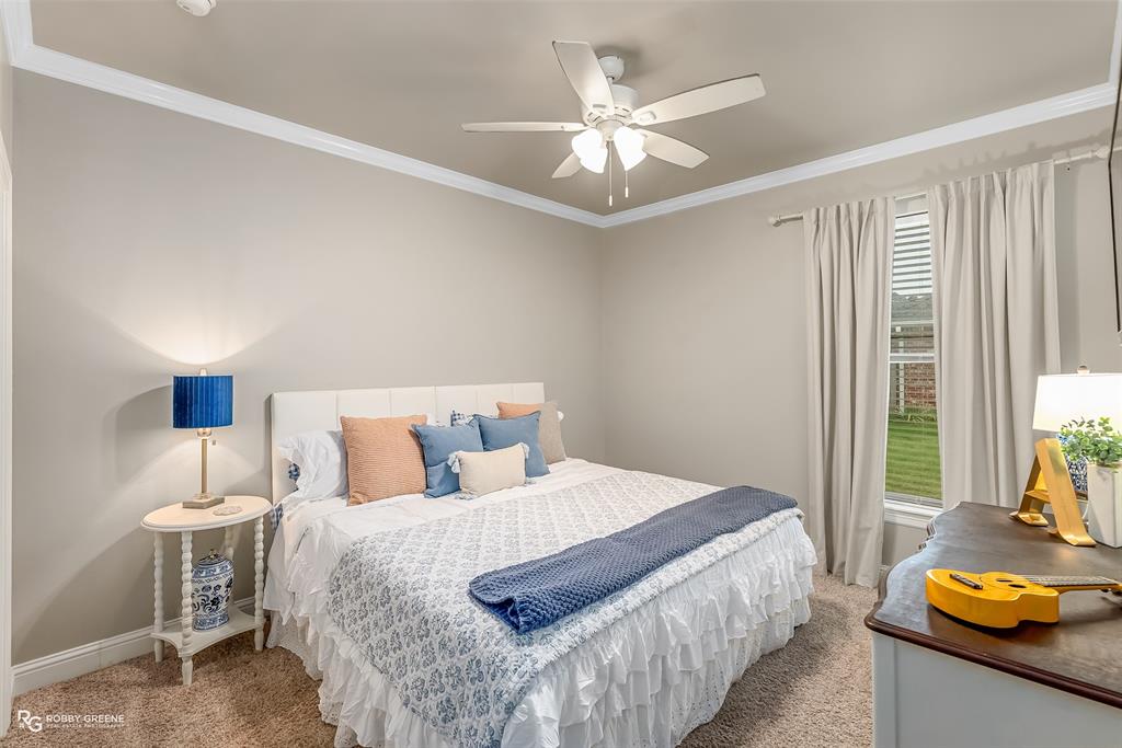 425 Kingston Road Benton, LA 71006 - Photo 22 of 35 a bedroom with a bed and a chandelier