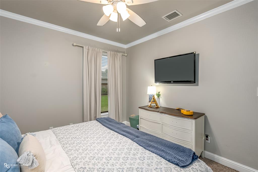 425 Kingston Road Benton, LA 71006 - Photo 23 of 35 a bedroom with a bed and a flat screen tv