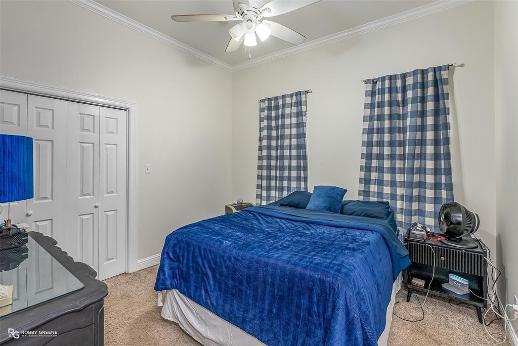 425 Kingston Road Benton, LA 71006 - Photo 24 of 35 a bedroom with a bed and a chandelier