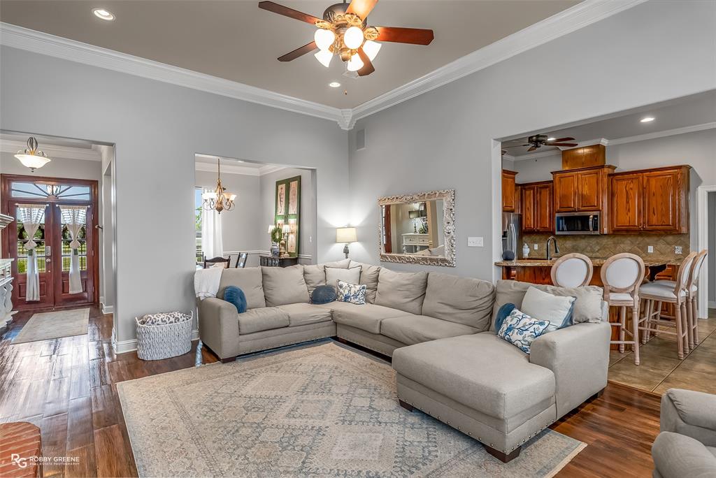425 Kingston Road Benton, LA 71006 - Photo 6 of 35 a living room with furniture a chandelier and a flat screen tv