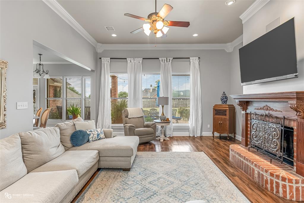425 Kingston Road Benton, LA 71006 - Photo 8 of 35 a living room with fireplace furniture and a flat screen tv
