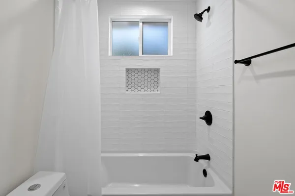 a bathroom with a bathtub and a shower