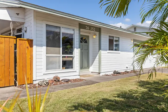 a kitchen with stainless steel appliances granite countertop a sink a stove and a white cabinets