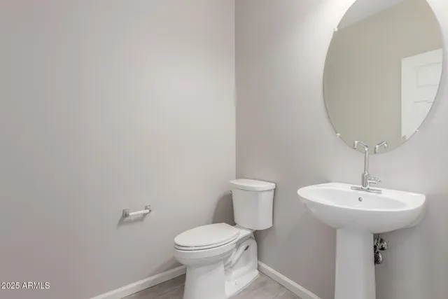 a bathroom with a sink a toilet and mirror