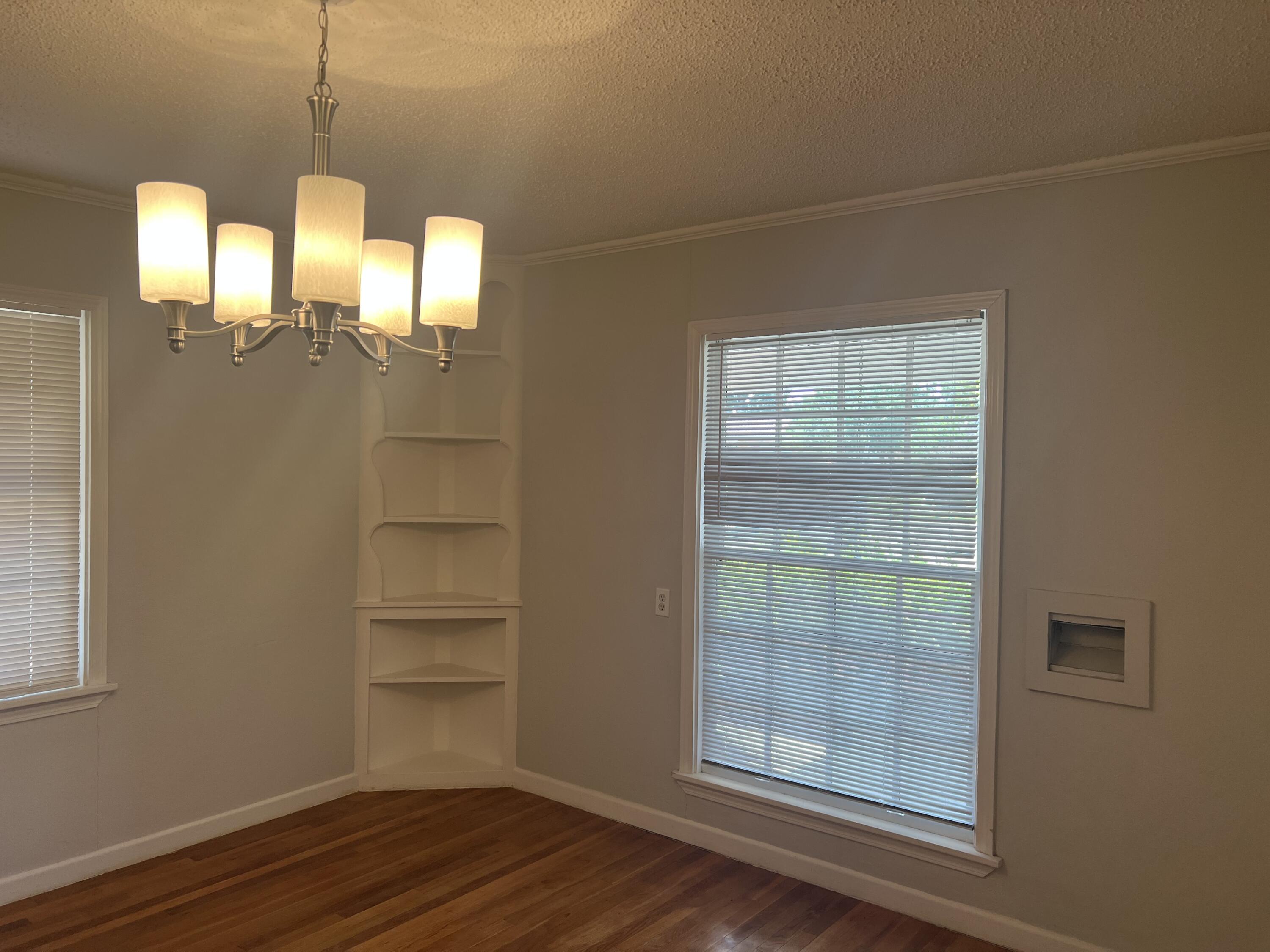 2424 33rd Street Lubbock, TX 79411 - Photo 13 of 23 a view of a room with wooden floor and windows