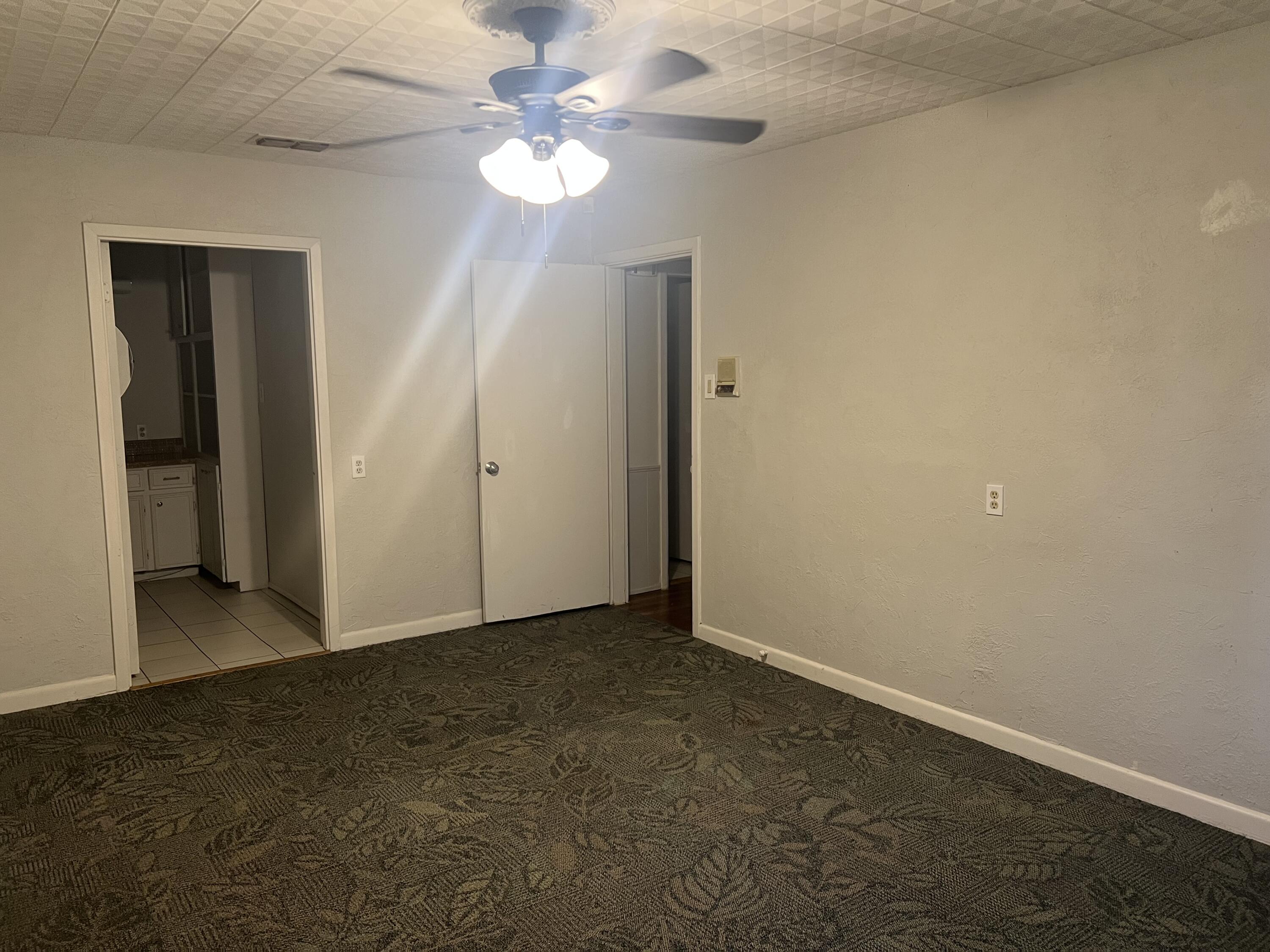2424 33rd Street Lubbock, TX 79411 - Photo 18 of 23 an empty room with a chandelier fan and closet