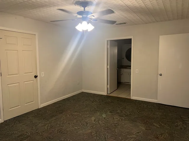 a view of an empty room with a fan