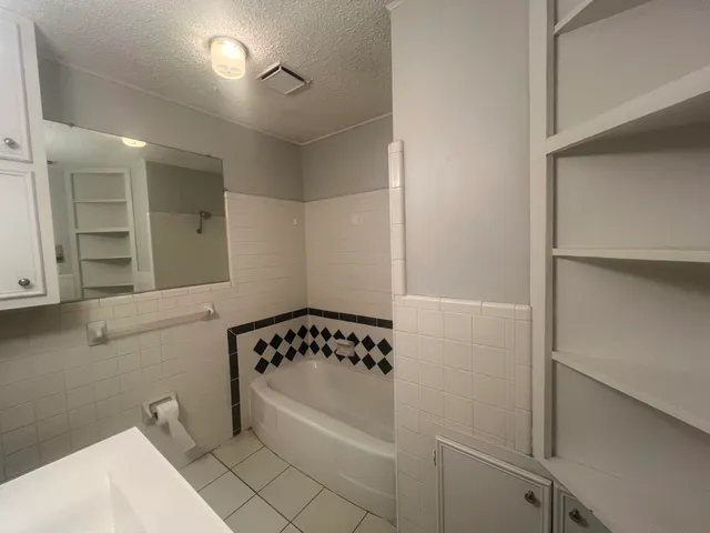 a bathroom with a bathtub and shower