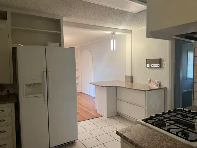 a kitchen with cabinets and a stove top oven
