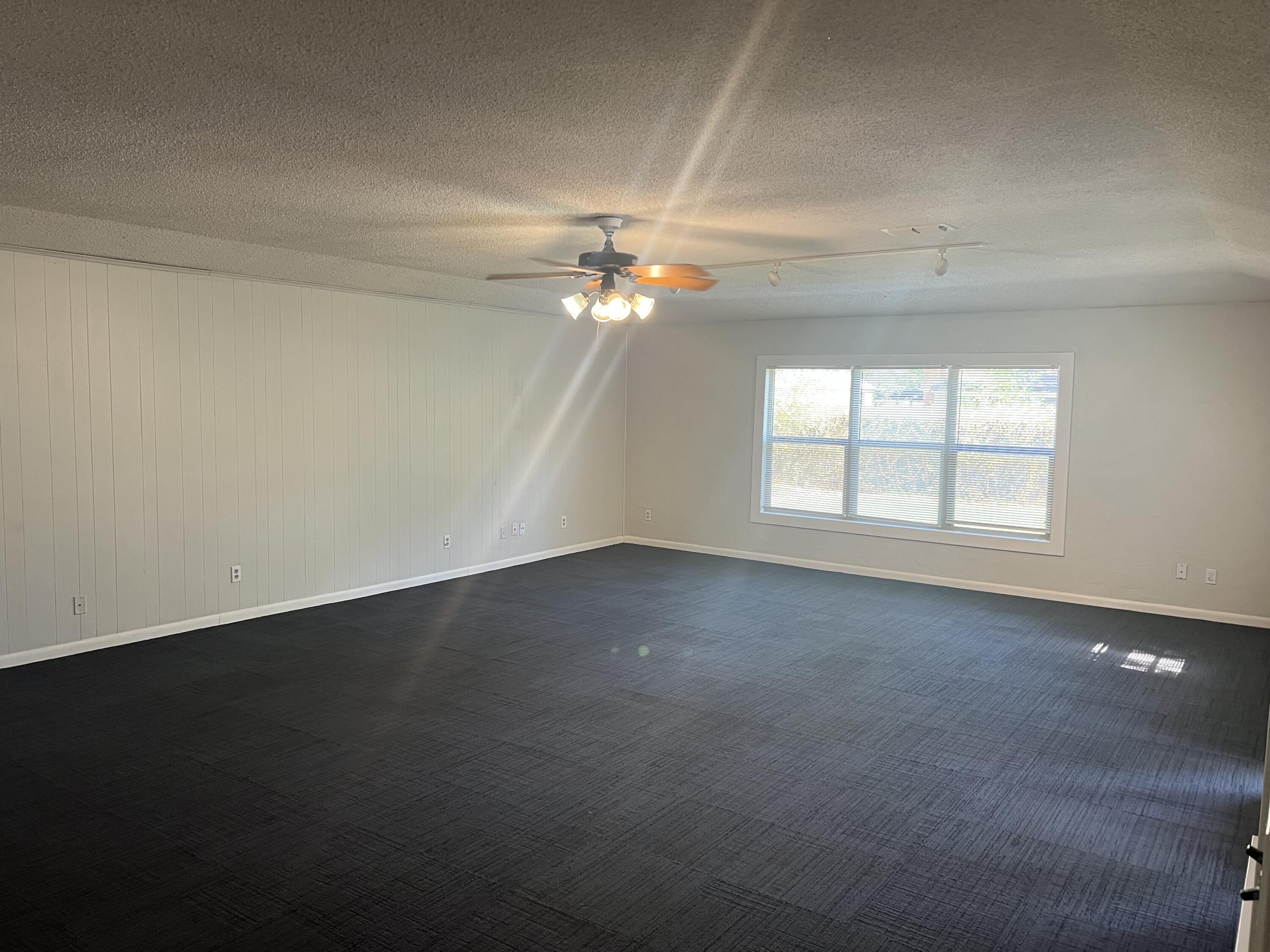 2424 33rd Street Lubbock, TX 79411 - Photo 7 of 23 an empty room with a window and a ceiling fan