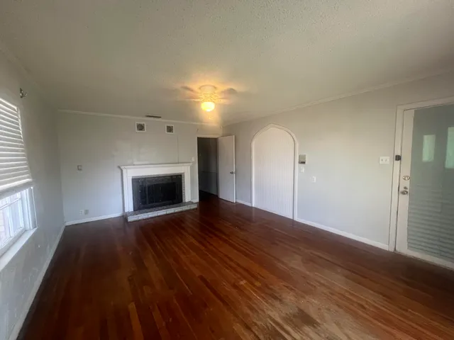 wooden floor fireplace and natural light in room