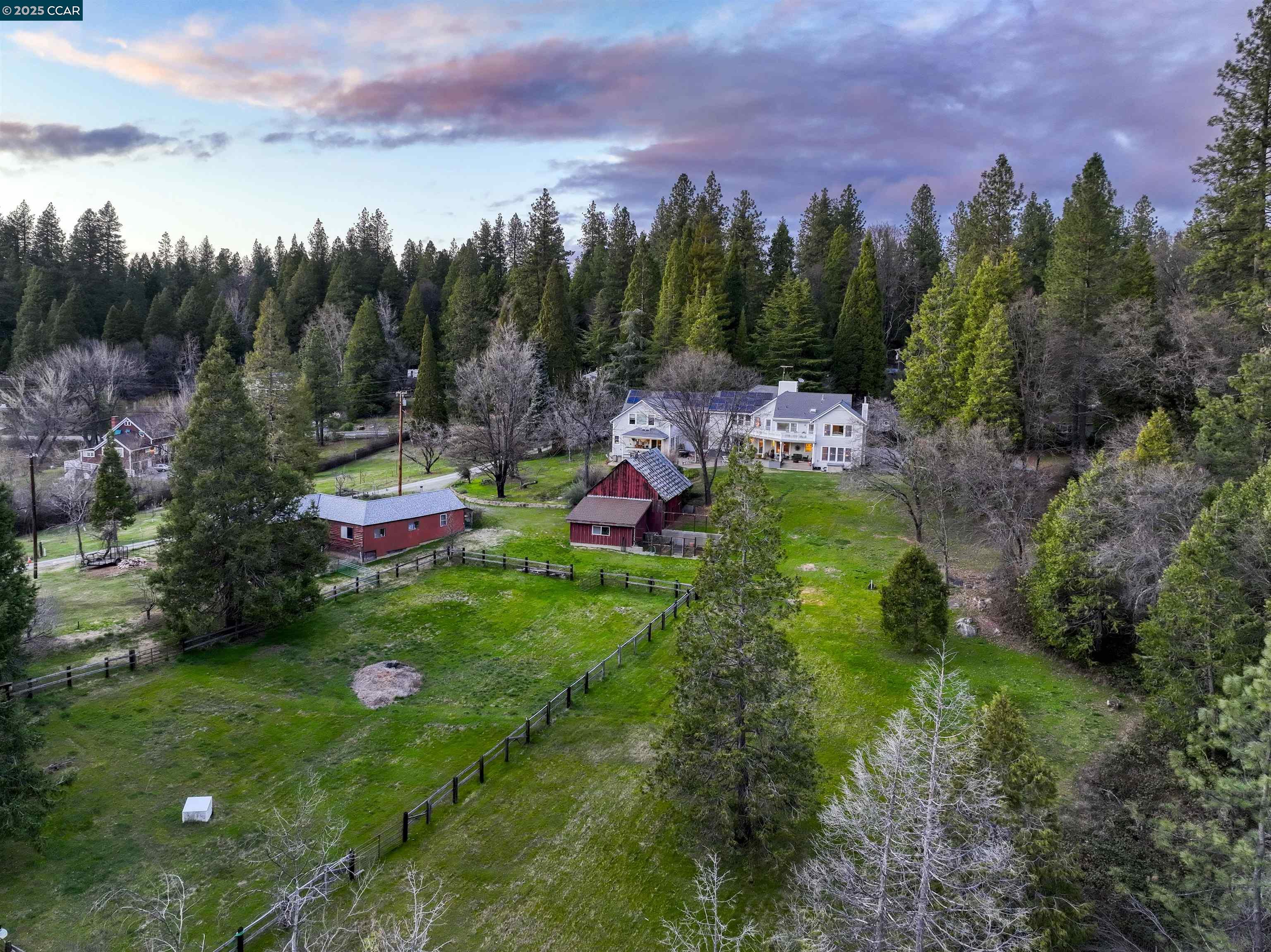 11417 Red Dog Road Nevada City, CA 95959 - Photo 27 of 56 a backyard of a house with lots of green space and mountain view in back