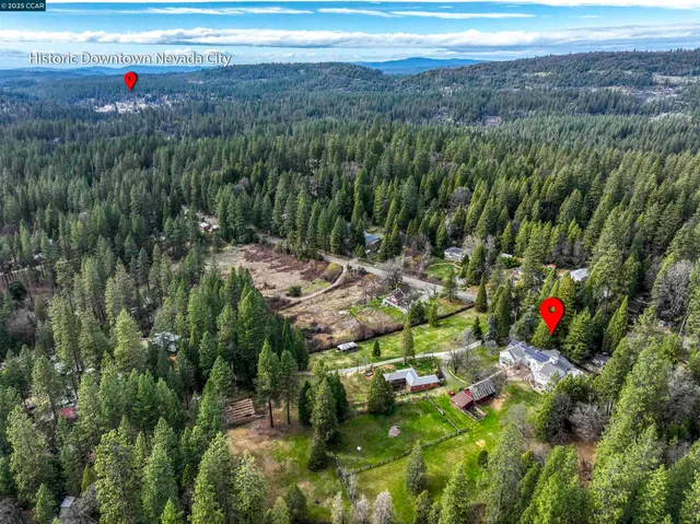 a front view of a house with a yard table and chairs