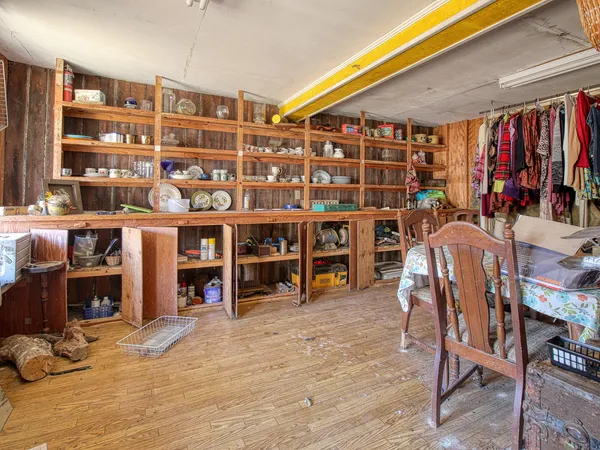 a front view of a house with porch and garden