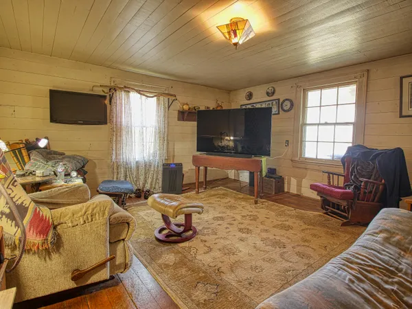 a bedroom with a bed window and a couch