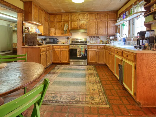 a kitchen with stainless steel appliances granite countertop a refrigerator and a sink
