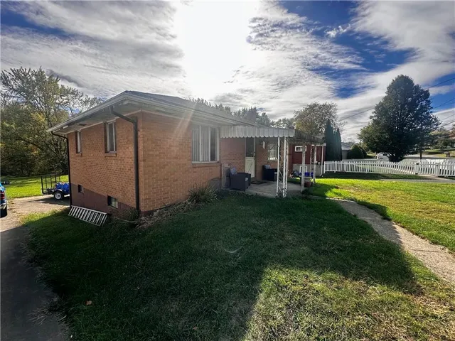 a view of a house with swimming pool and a yard