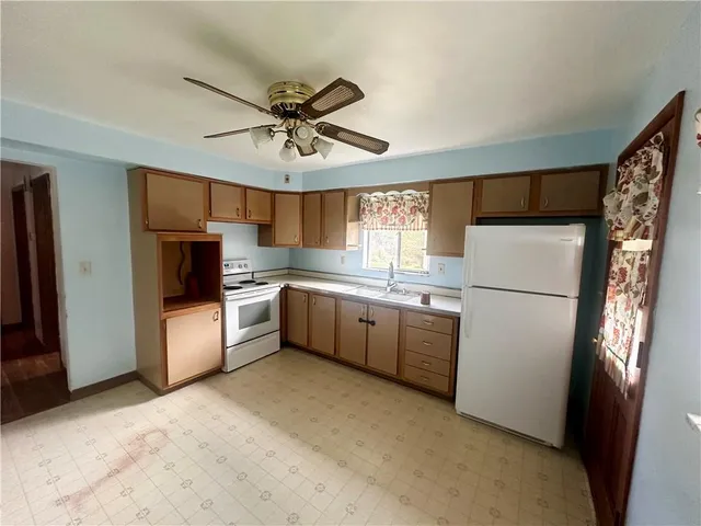 a kitchen with a refrigerator a stove top oven a sink and dishwasher