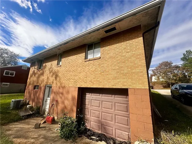 a view of a backyard with table and chairs potted plants and large tree