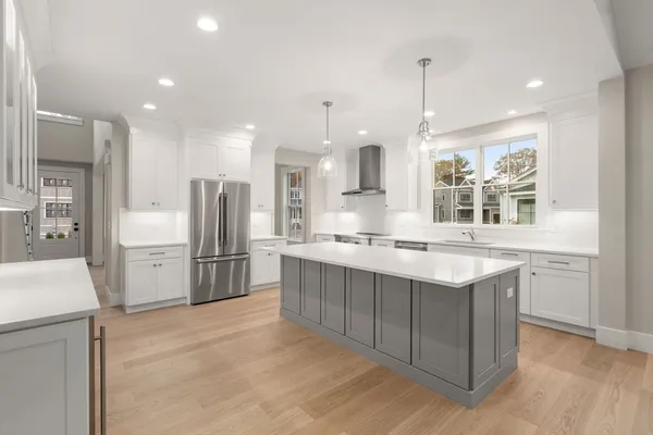 a kitchen with refrigerator cabinets and wooden floor