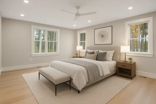 a bedroom with a large bed and windows