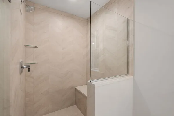 a bathroom with a glass shower door