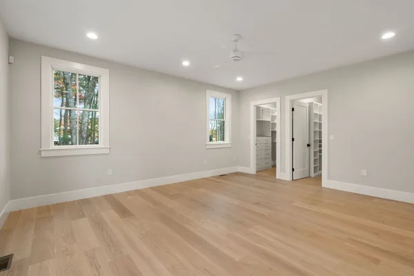 an empty room with windows and closet