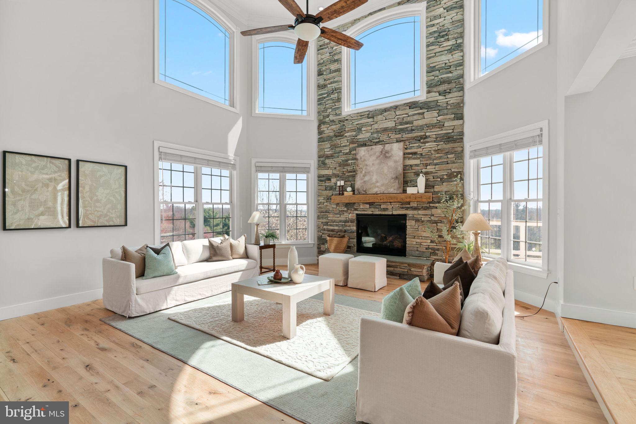 25114 Vista Ridge Road Laytonsville, MD 20882 - Photo 13 of 97 a living room with furniture a fireplace and a floor to ceiling window