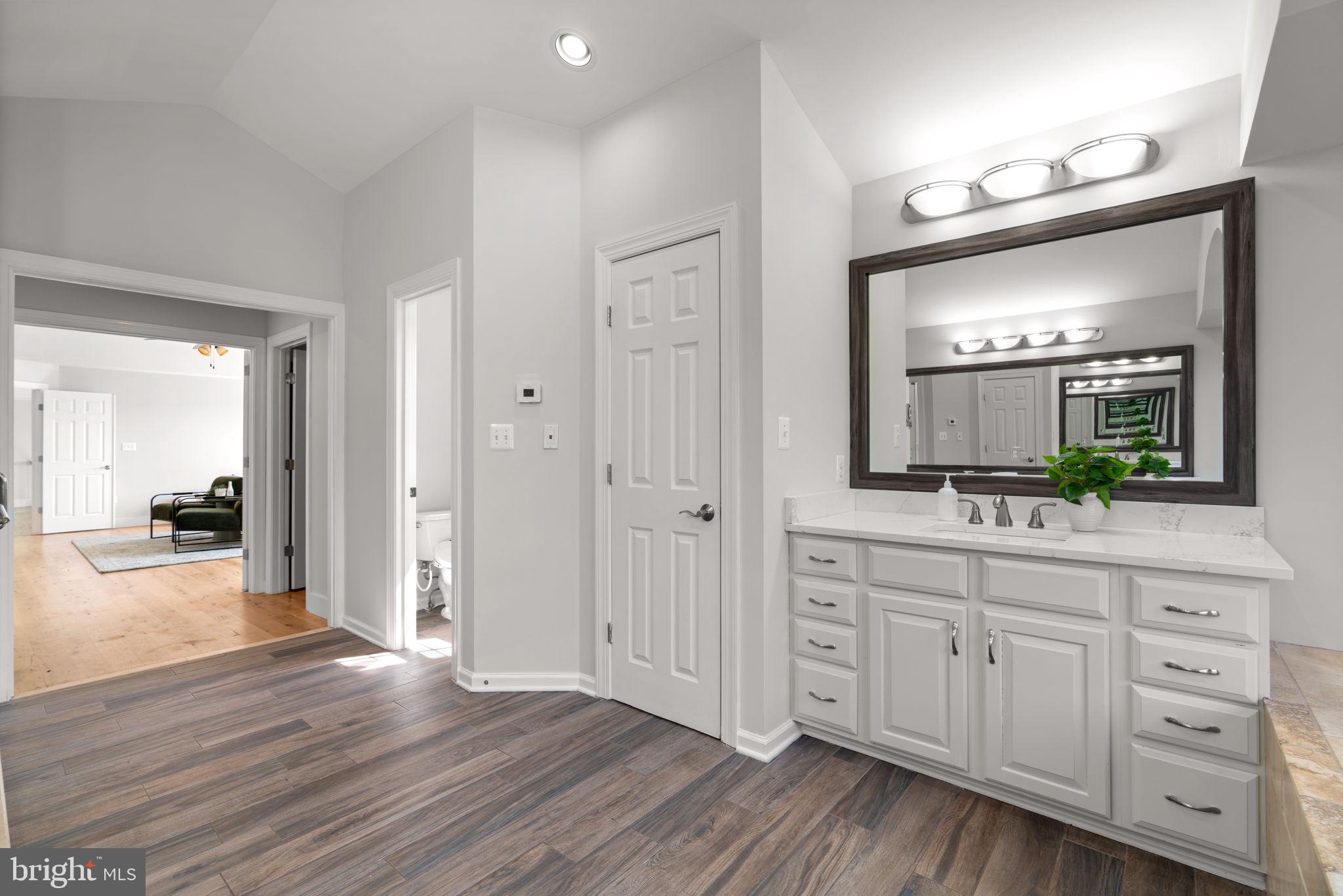 25114 Vista Ridge Road Laytonsville, MD 20882 - Photo 41 of 97 a spacious bathroom with a granite countertop sink mirror and