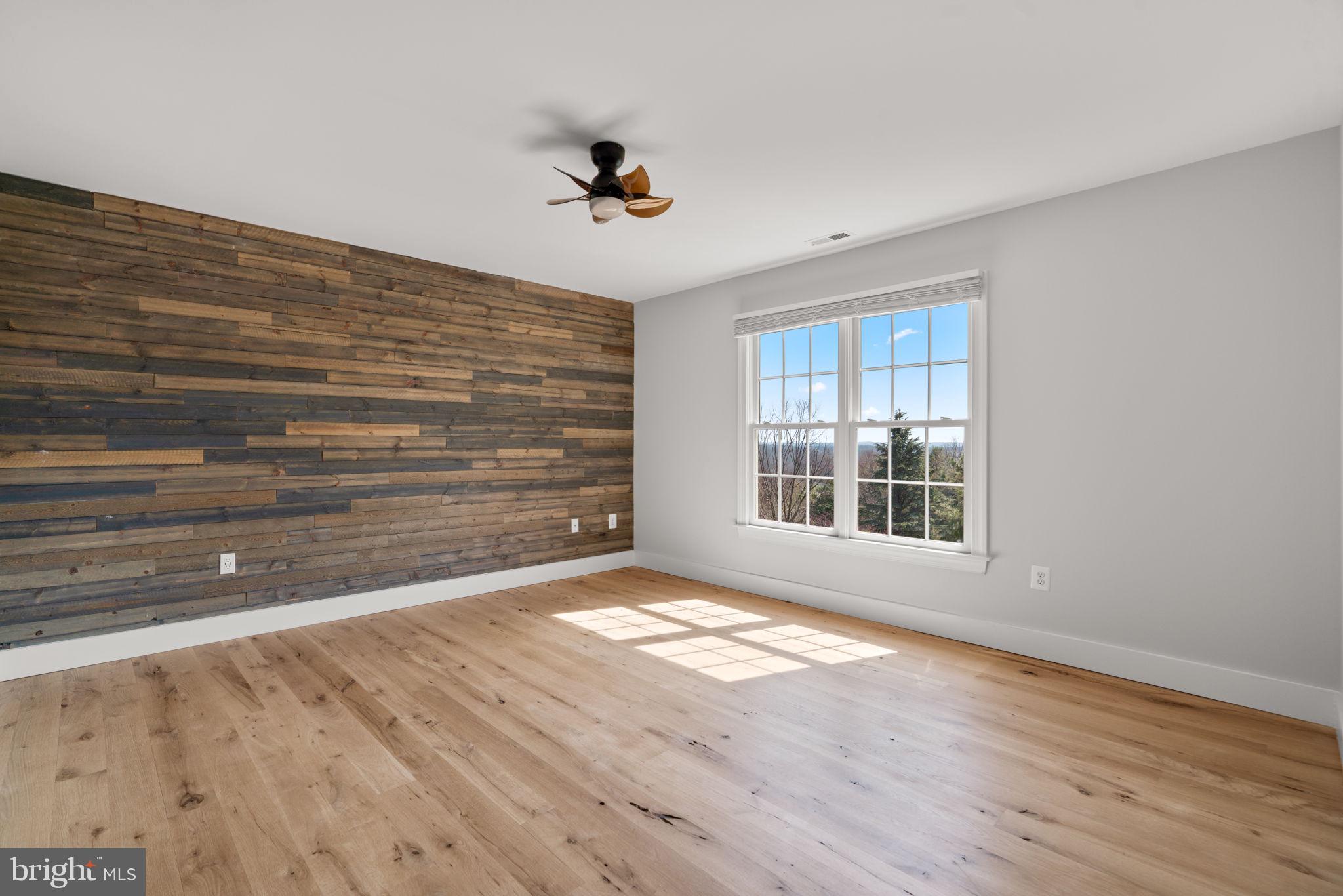 25114 Vista Ridge Road Laytonsville, MD 20882 - Photo 48 of 97 a view of an empty room with a window and wooden floor