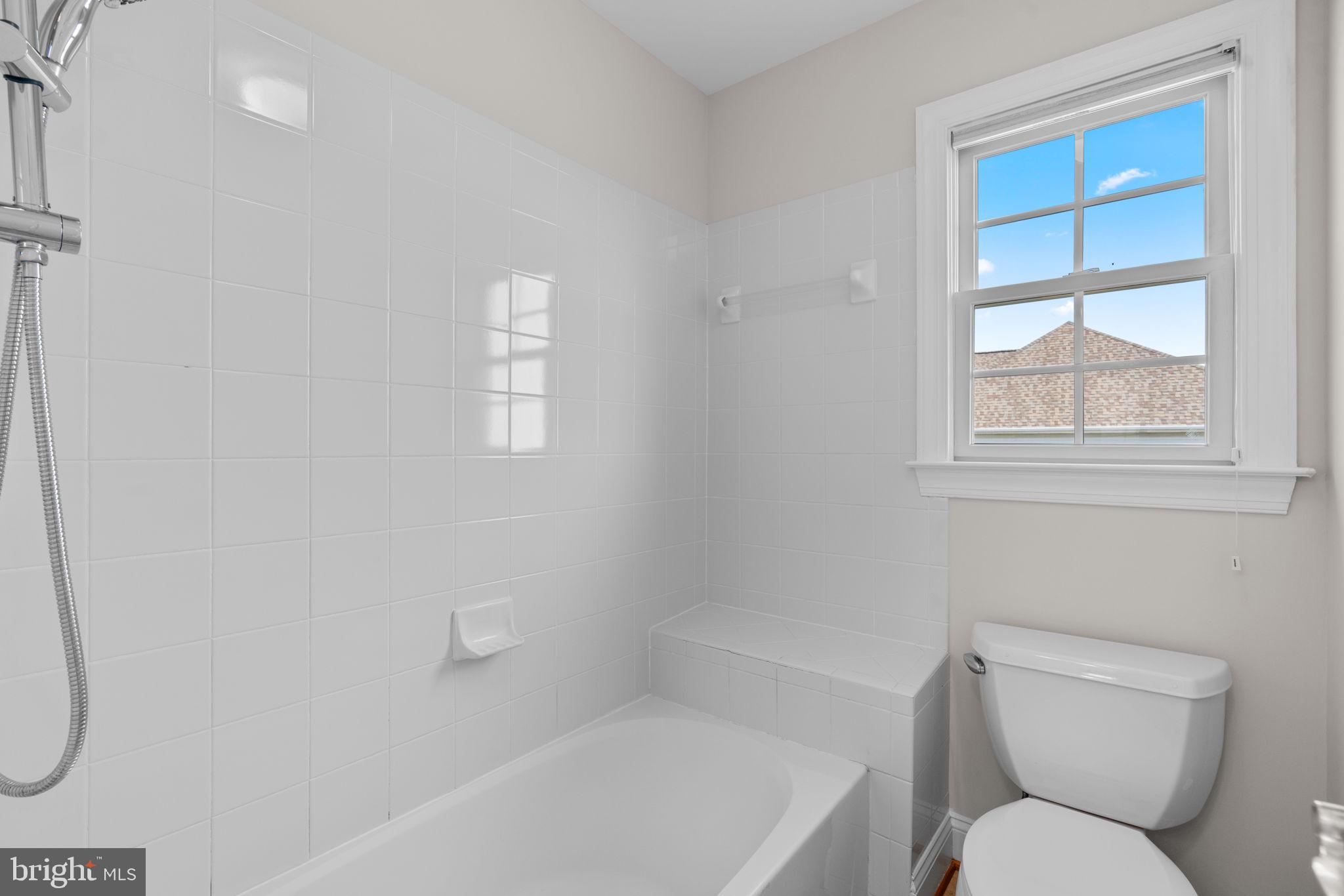 25114 Vista Ridge Road Laytonsville, MD 20882 - Photo 50 of 97 a white toilet sitting next to a bath tub and a window
