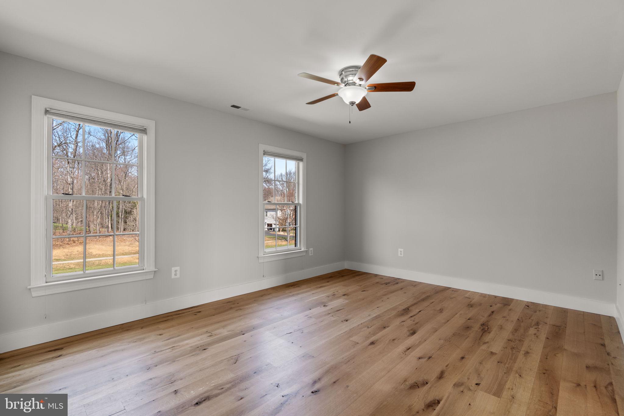 25114 Vista Ridge Road Laytonsville, MD 20882 - Photo 52 of 97 a view of an empty room with wooden floor and a window