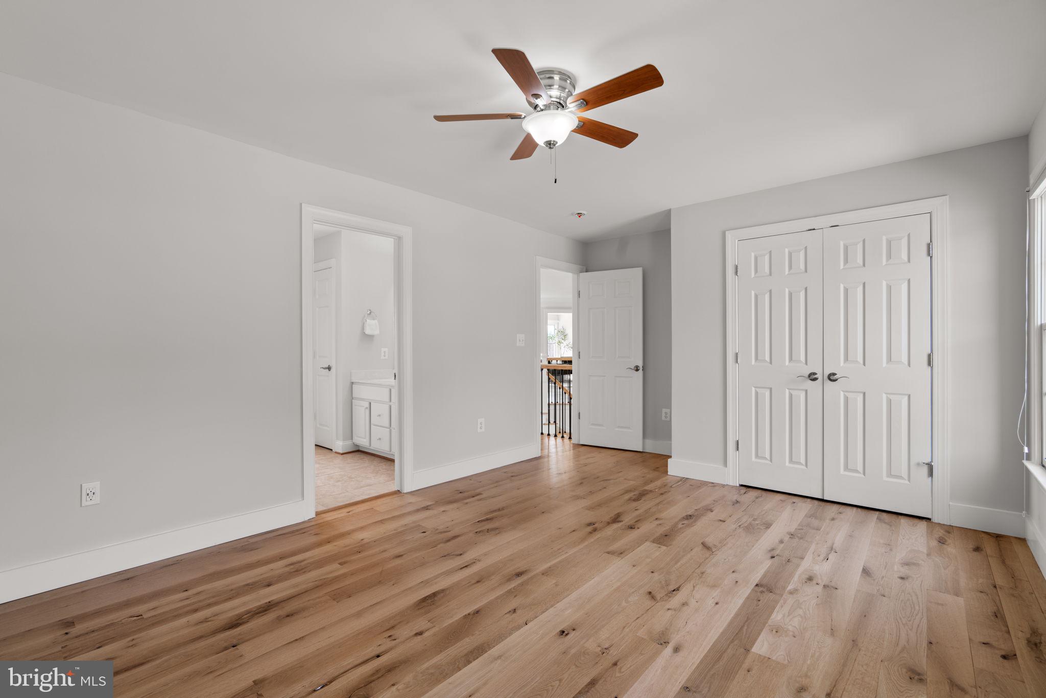 25114 Vista Ridge Road Laytonsville, MD 20882 - Photo 53 of 97 an empty room with wooden floor and ceiling fan