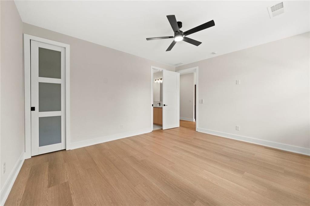 7066 Bells Way Fairburn, GA 30213 - Photo 52 of 64 a view of empty room with wooden floor and ceiling fan