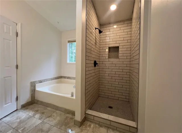 a bathroom with a shower and bathtub