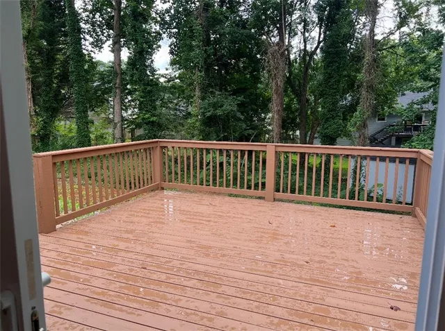 a view of balcony with wooden floor and fence