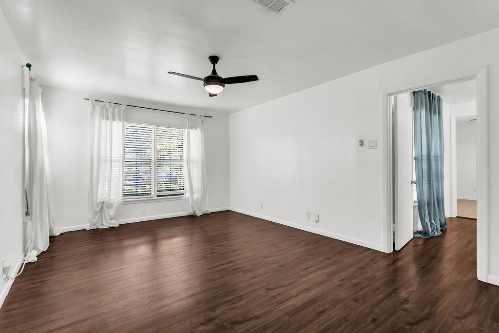 9440 Magnolia Road Frisco, TX 75033 - Photo 14 of 29 a view of an empty room with wooden floor and a window