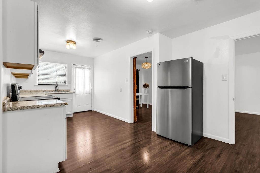 9440 Magnolia Road Frisco, TX 75033 - Photo 5 of 29 a kitchen with stainless steel appliances a refrigerator and a stove top oven