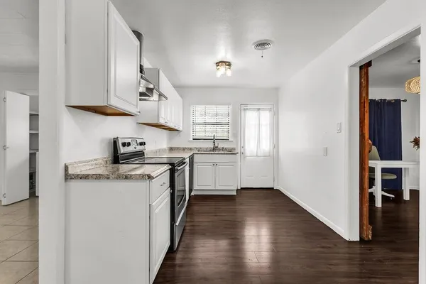 a kitchen with stainless steel appliances granite countertop a stove and a refrigerator