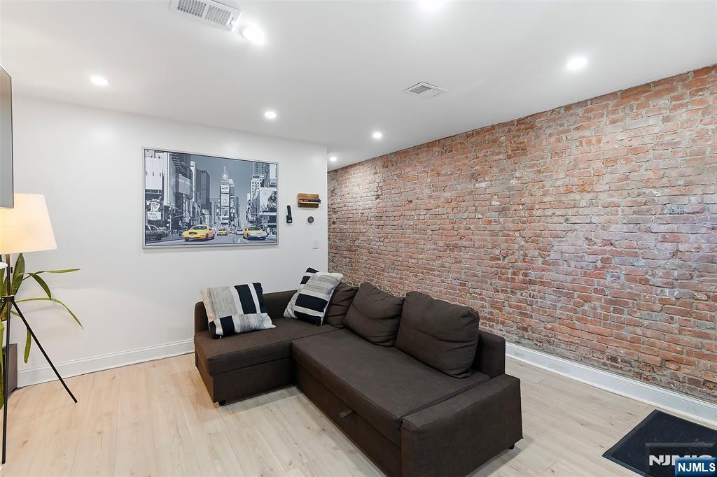 22 8th Avenue Newark, NJ 07104 - Photo 5 of 26 a living room with furniture and a flat screen tv