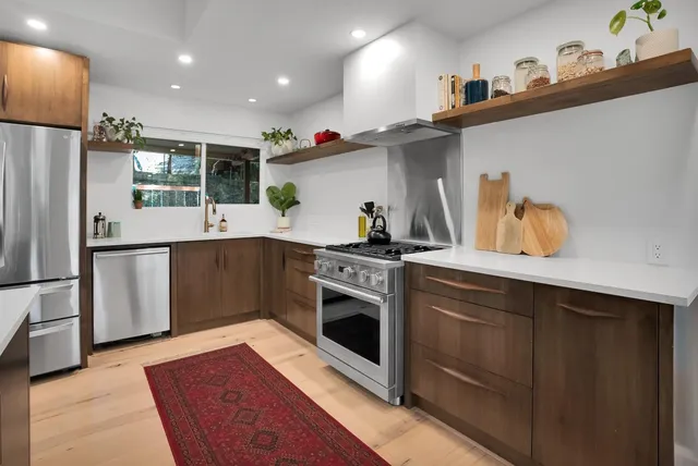 a bedroom with a large bed and a flat tv screen on dresser
