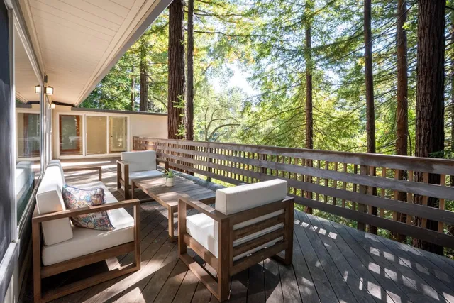 a view of balcony with wooden floor and outdoor seating